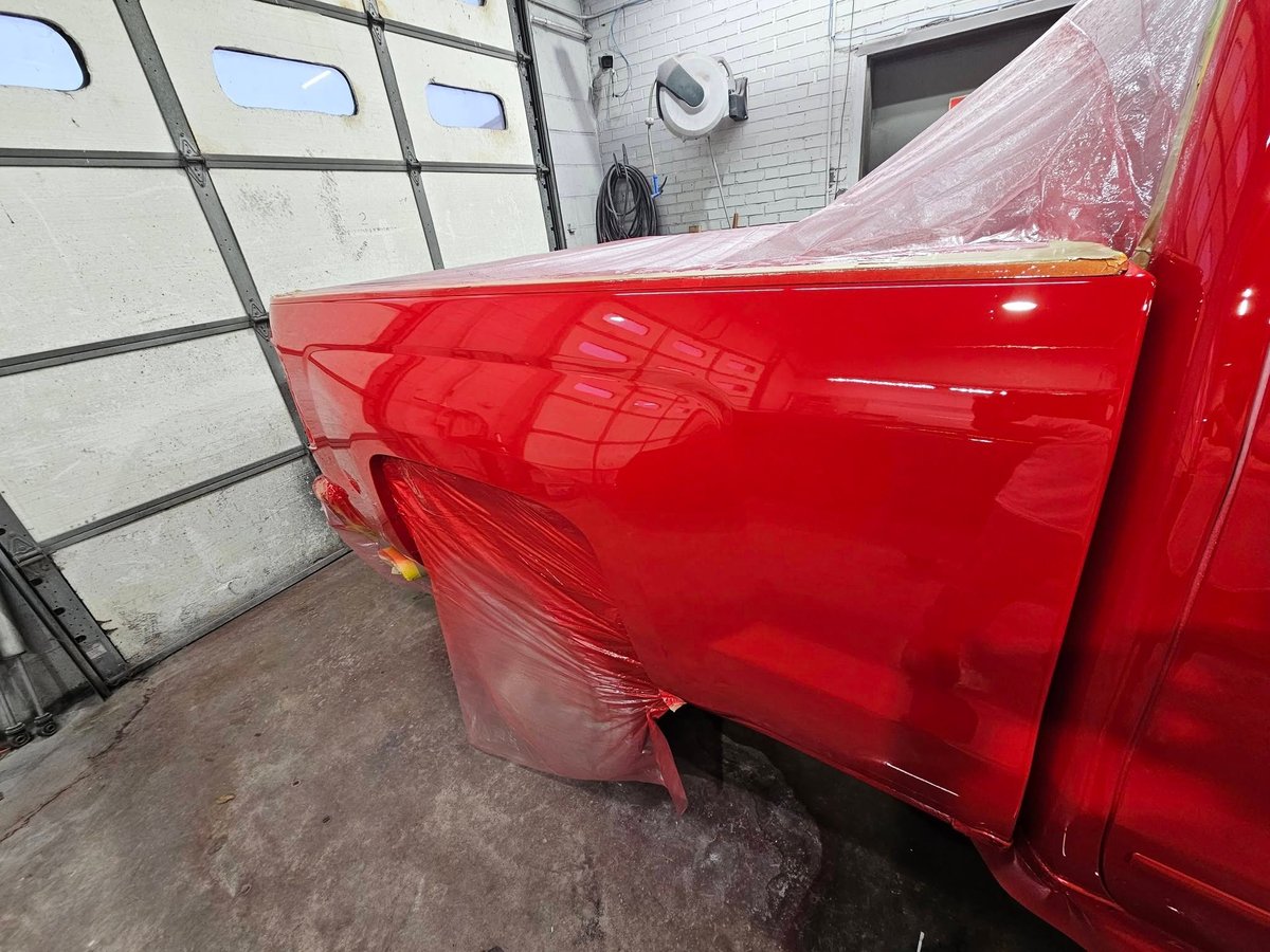 Truck bed masked with plastic sheeting in the paint bay
