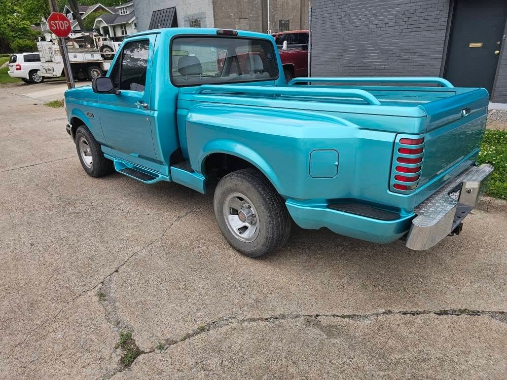 Restored pickup with the door open showing finished body work